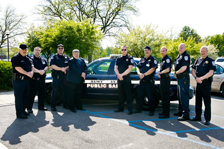 SUNY Ulster Public Safety & Security officers posing in front of police cruiser