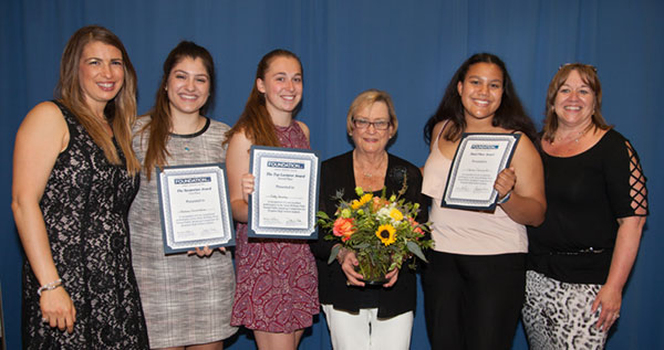 Students holding awards with Anita Williams Peck