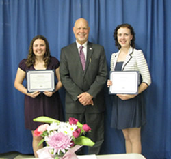 Chamber Scholarship Presentation with two students holding awardsand older man