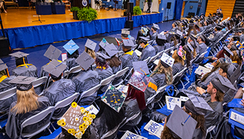 view of tops of mortarboards in gym at graduation