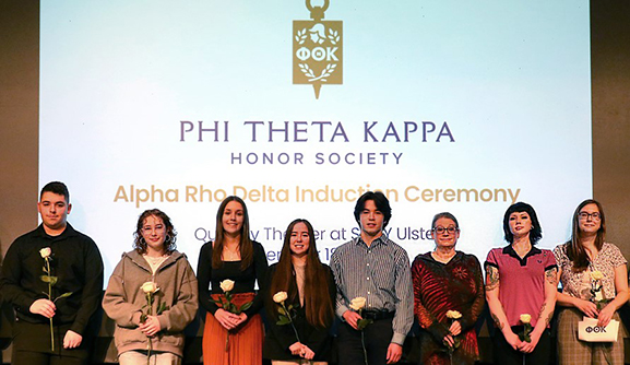 Students from Phi Theta Kappa program at event