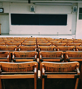 classroom with blackboard and wooden chairs