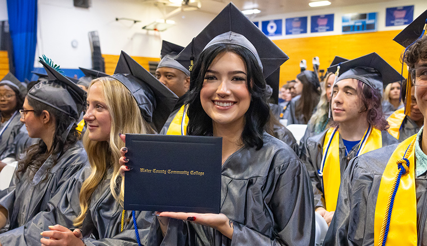 woman with diploma at graduation