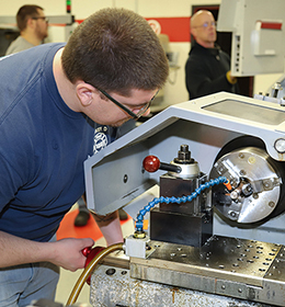 man looking at machine