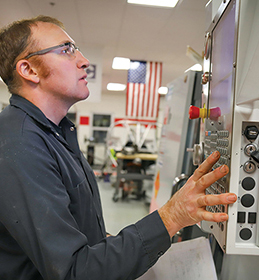 man with engraved label and machine