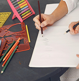 children's hands with art supplies