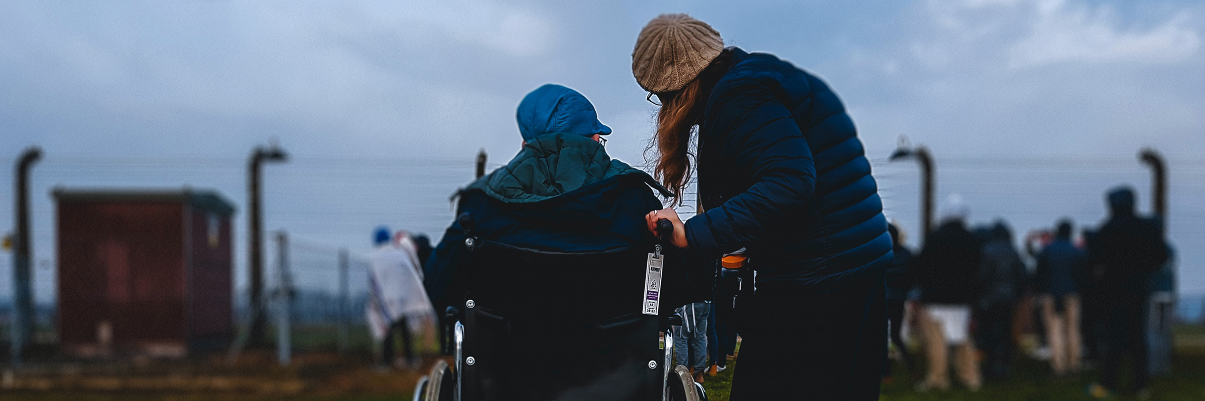 person helping person in wheelchair