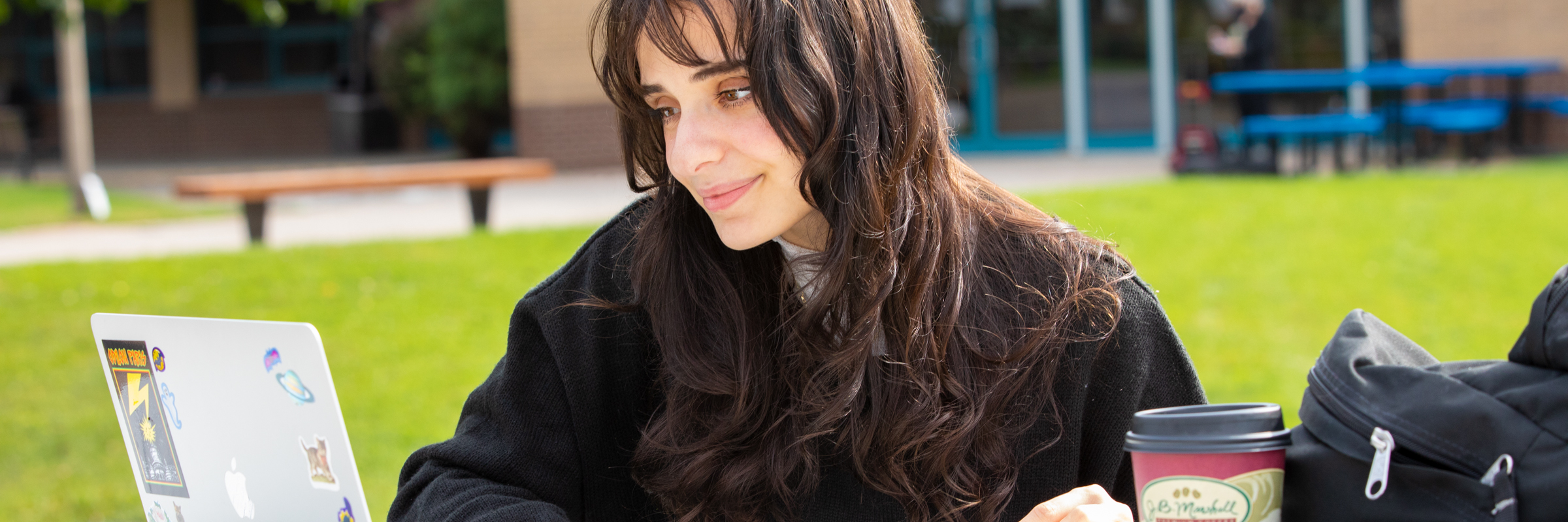 woman studying at computer outside on SUNY Ulster campus