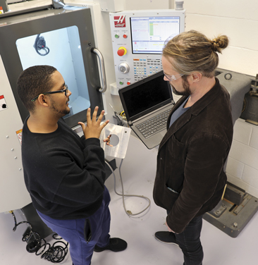 two students speaking in a lab