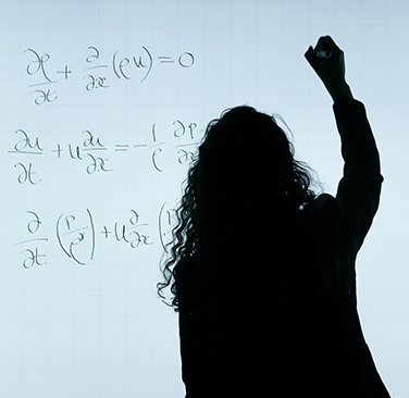 silhouette of woman writing math on whiteboard