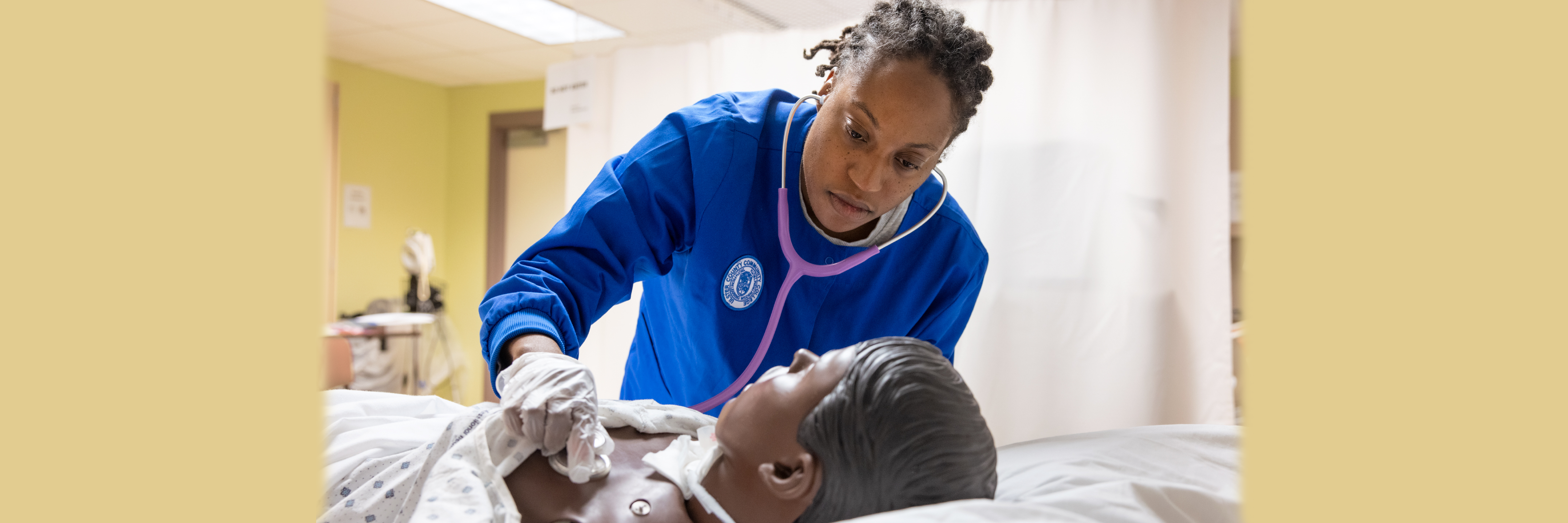 nurse leaning over dummy