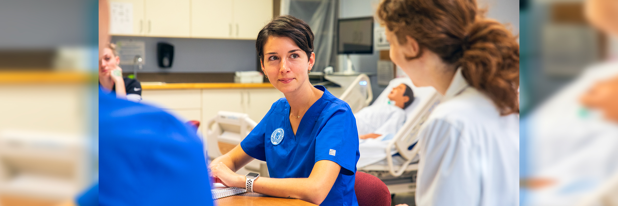 nurse leaning over dummy