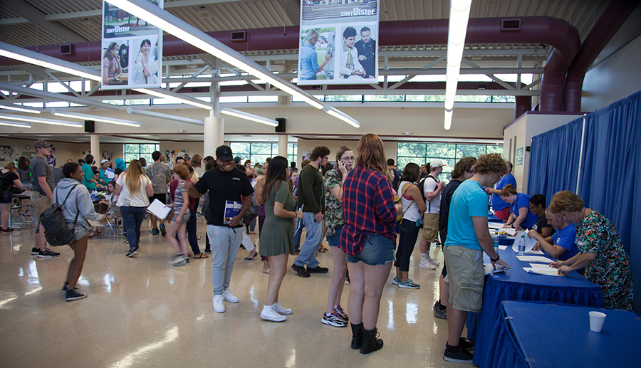 busy dining hall with students waiting in lines