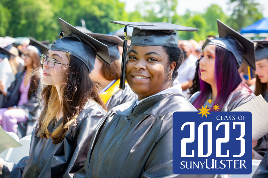 diverse students in caps and gown at grad ceremony