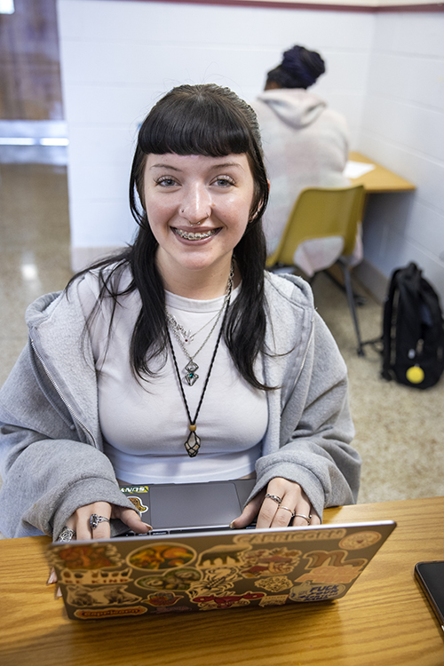 young woman with braces at laptop