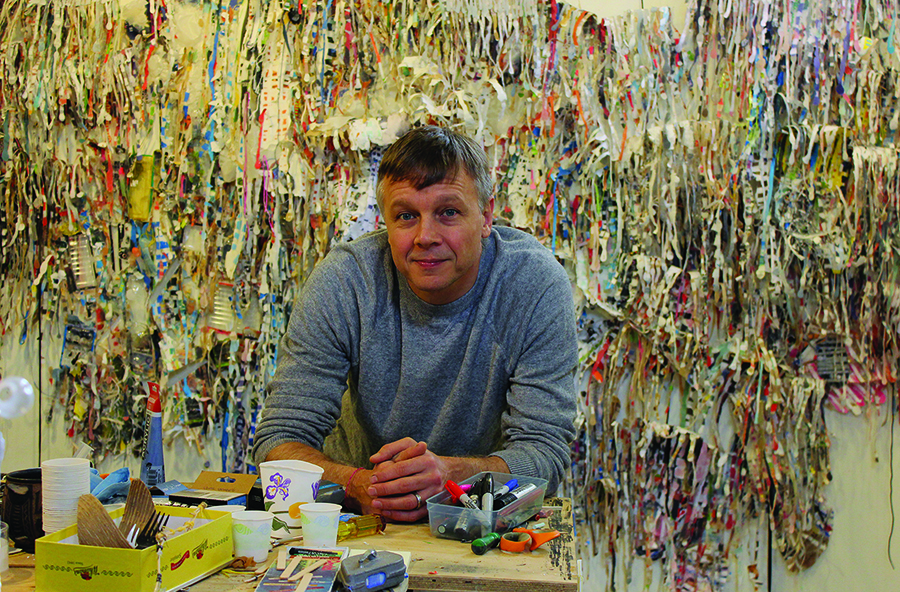 image of man in art studio with arms resting on desk