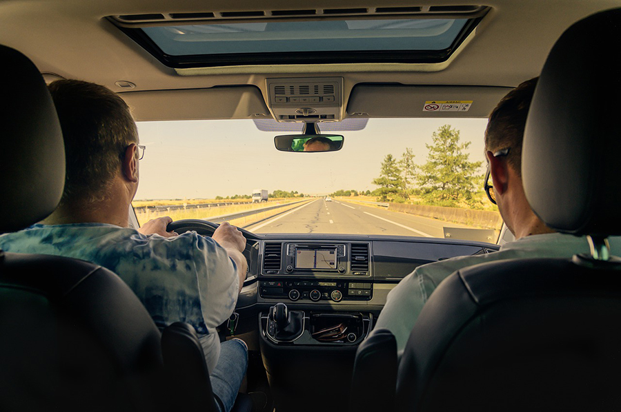 two people in car looking out at the road