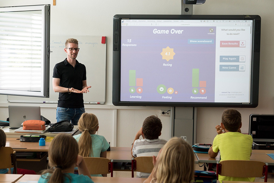 educator with students and smartboard