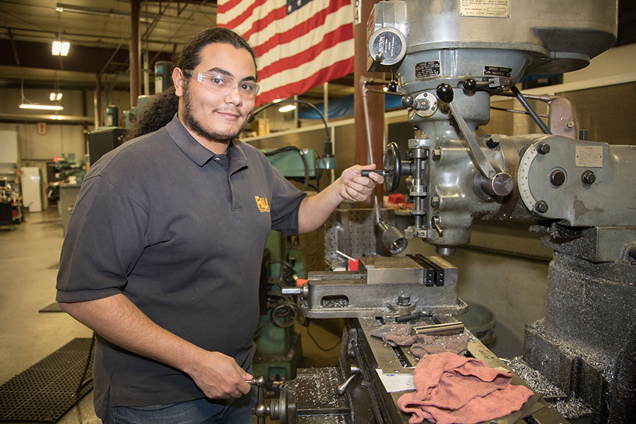 man smiling with industrial equipment