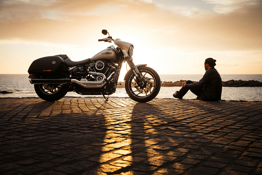 motorcycle and guy looking out at water