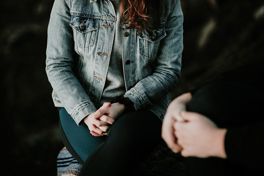 view of people's hands clenched while in conversation