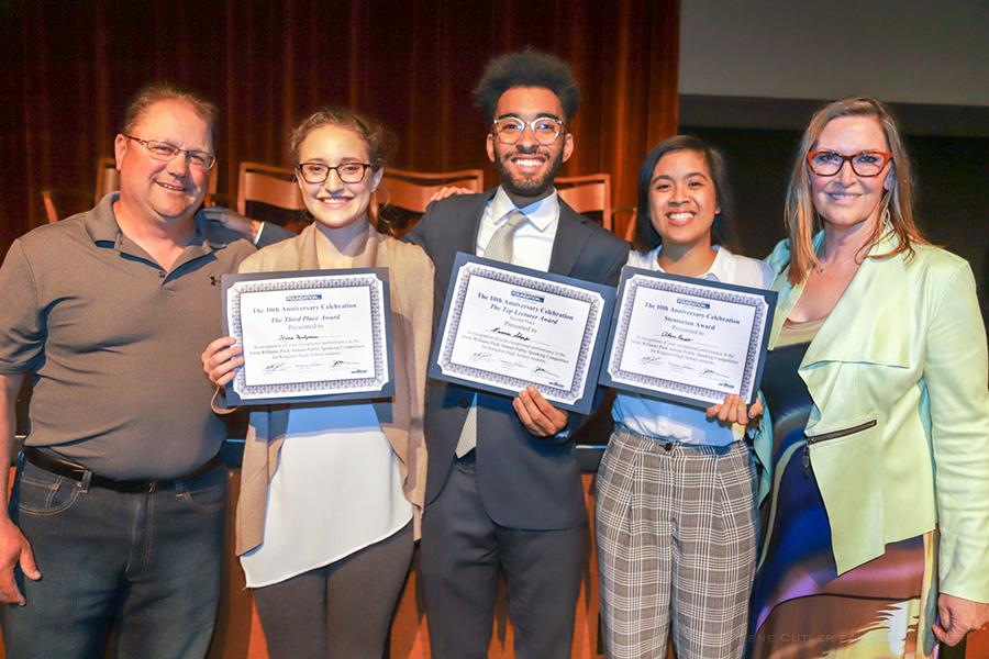 Students holding awards with Anita Williams Peck