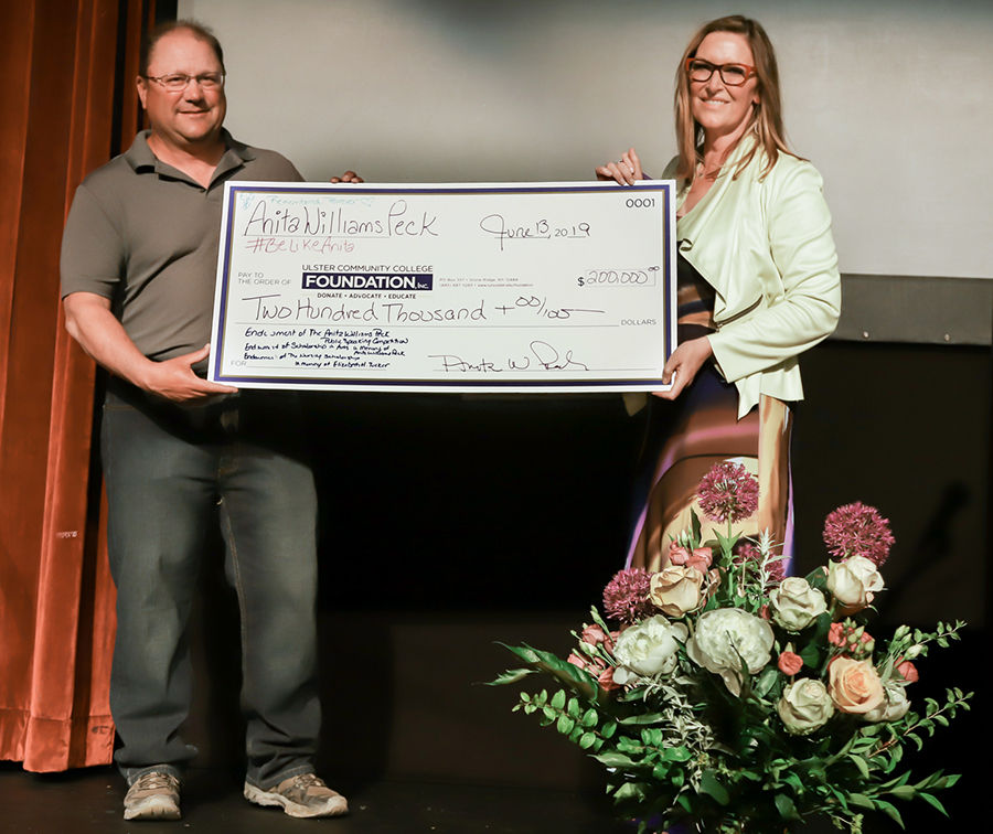 Students holding awards with Anita Williams Peck