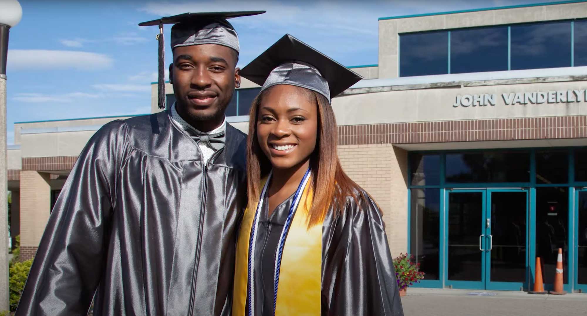 two graduates in graduation regalia