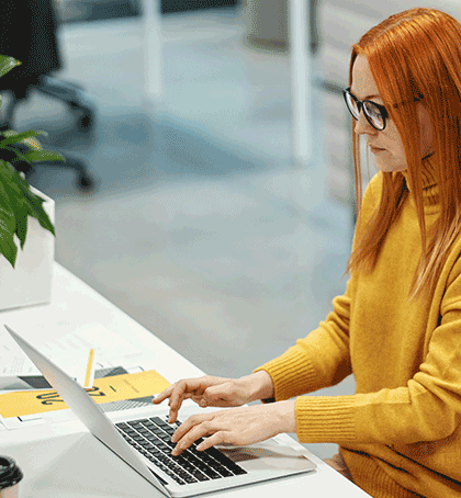 woman in office setting on computer