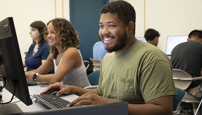 smiling students at computers