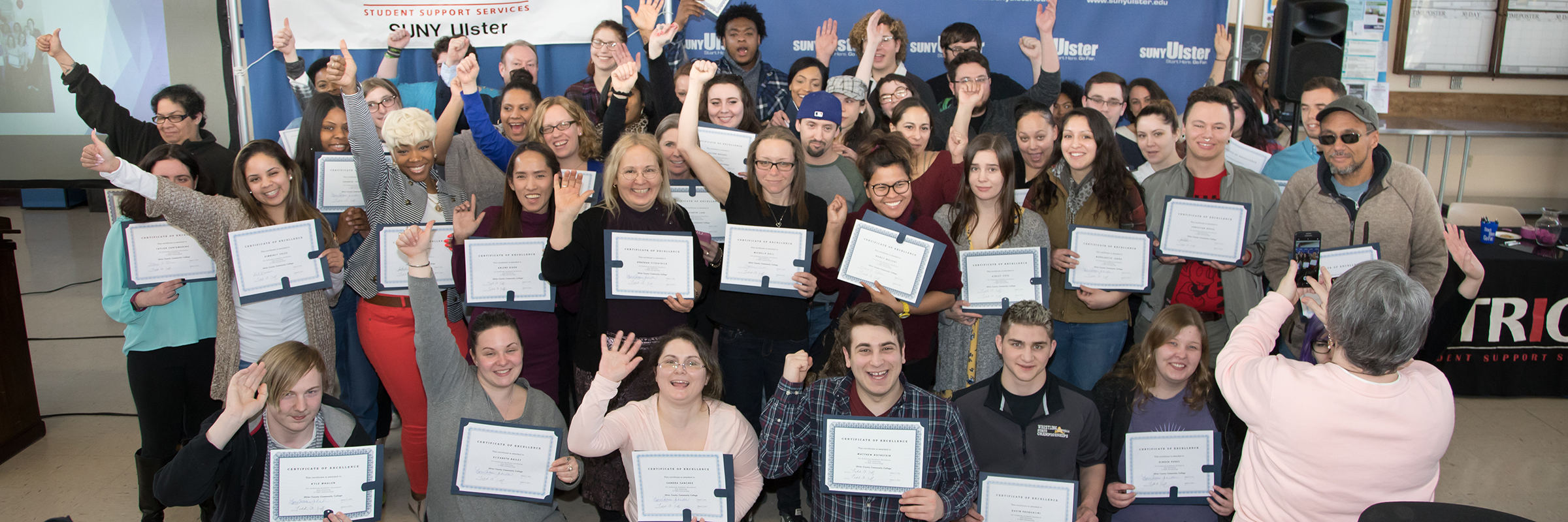 group of trio program graduates holding certificates